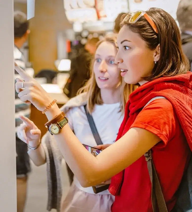 Two women looking in awe at screen