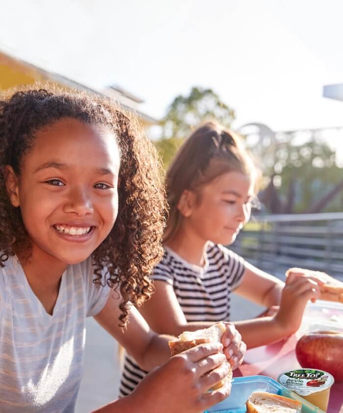 Girls eating school lunch outside